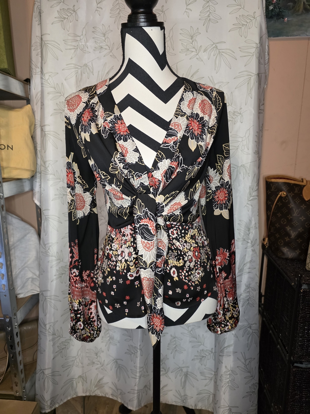 Free People Run Free floral blouse features a striking black and red boho print